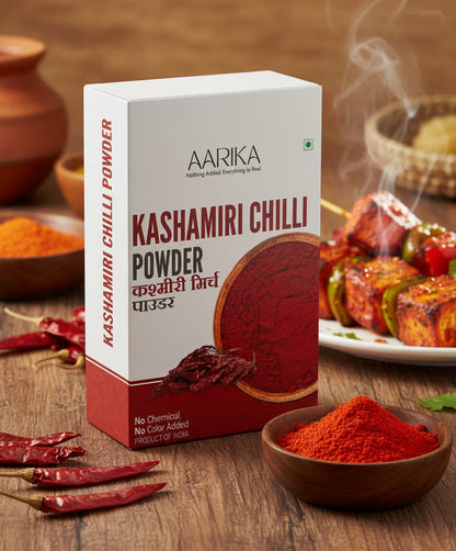 Flavorful kitchen king masala for sabji and curry Best kitchen king masala spice mix for Indian cooking Aarika Kashmiri Chilli Powder packaging with chili peppers and food in the background