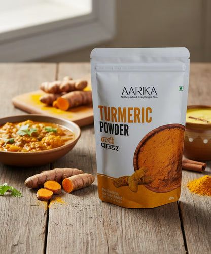 Organic turmeric powder with natural golden color Turmeric powder for immunity, digestion, and wellness Aarika Turmeric Powder package on a wooden surface with turmeric roots and a dish of food. 